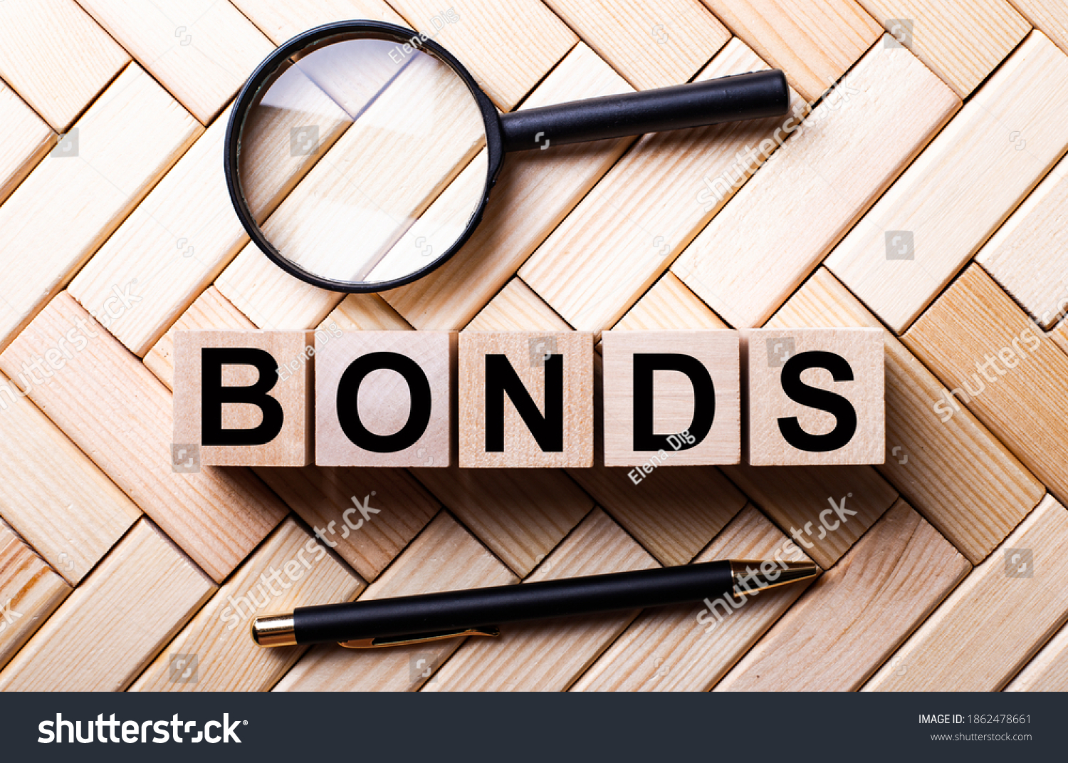 stock-photo-wooden-cubes-with-the-word-bonds-stand-on-a-wooden-background-between-a-magnifying-glass-and-a-1862478661